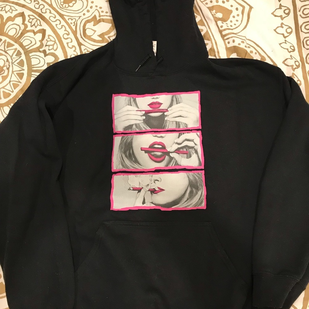 Black hoodie woman rolling joint